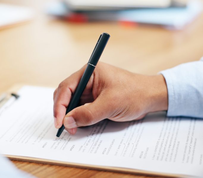 Closeup, hand and pen for clipboard in office for writing on legal form, compliance or application