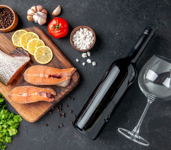 top-view-fresh-fish-with-lemon-bottle-of-wine-and-2023-11-27-05-22-17-utc